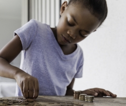 A young child counting coins