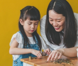 A mother and child counting coins 